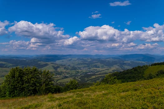 a magnificent landscape of a mountain valley with a city lying between the slopes