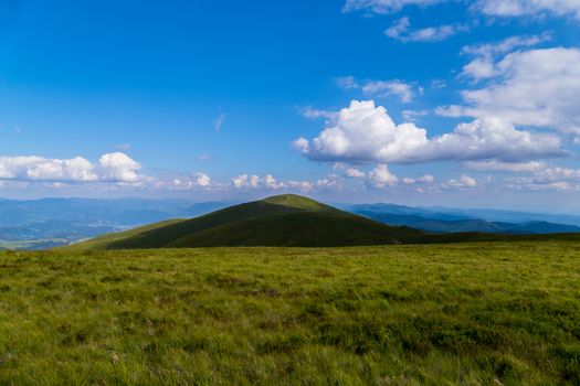 trampled path through the top of the mountain against the background of sky blue in the Carpathians