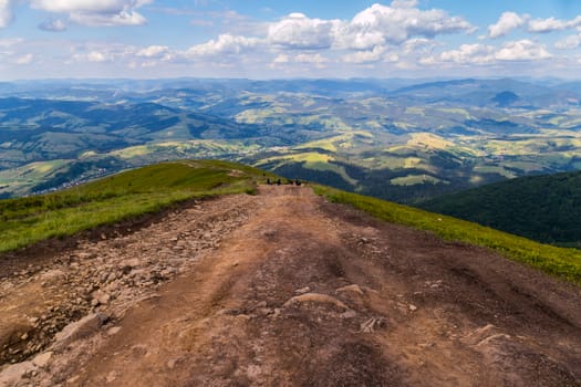 Steep descent from the mountainside against the background of a beautiful view of the surrounding landscapes