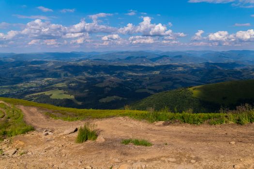 Plain with dry land with an excellent view of the green mountains, hills and valleys