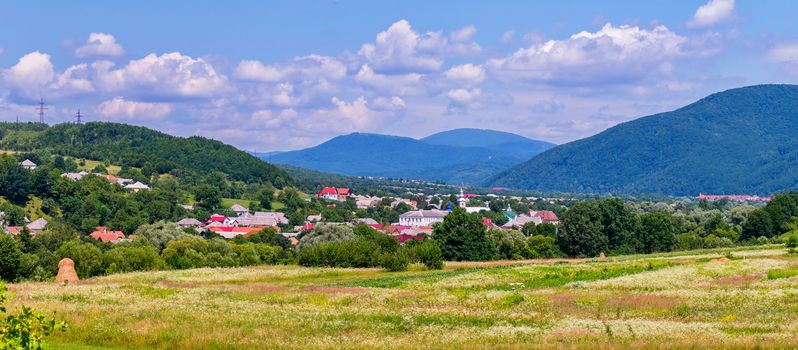 Transcarpathian city with bright roofs of buildings located on the plain near the Carpathian Mountains