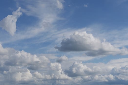 A majestic, endless blue sky with a lot of massive lush white clouds
