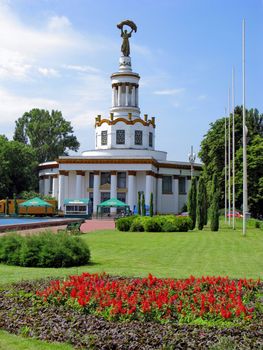 an excellent religious construction on the background of a green well-groomed lawn with flowers