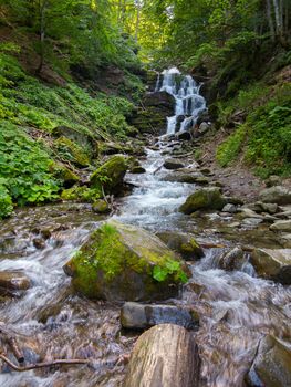The beautiful Shiepit falls on the rocky mountain rapids. Carpathians. Ukraine