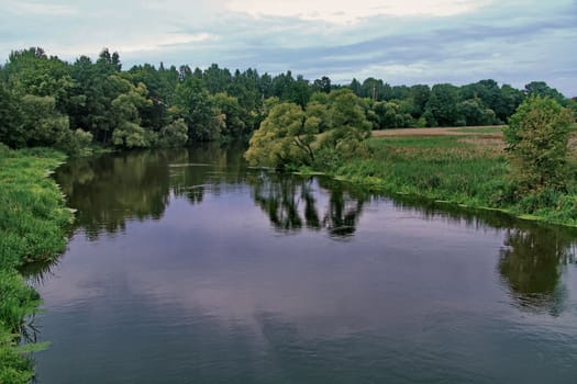 Transparent water surface, dividing the green forest zone into two banks