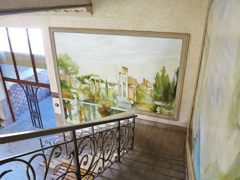 paintings with a picture of a garden near the stairs