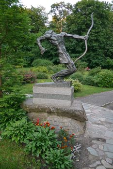 a statue in the park bent after archery is very original