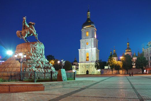 Monument to the hetman on a large rock galloping on a horse in front of a beautiful temple