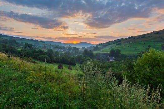 The picturesque sunset in the Carpathian village is fascinating for its beauty