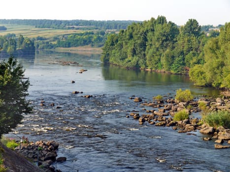 fast mountain river with rapids at noon