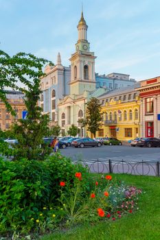 beautiful view from a green flower bed to a building of ancient architecture