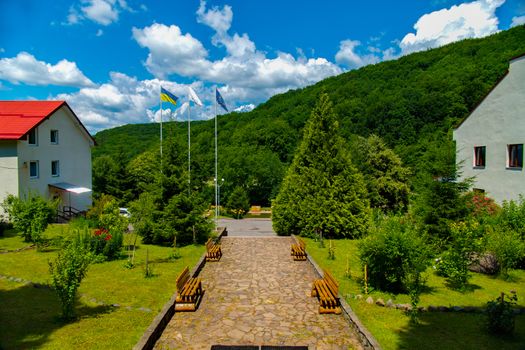 A small park alley with deaorativnymi plantations and hotel buildings on both sides of it