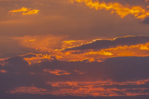The beauty of the evening sky with dense clouds and the sun trying to break through them.