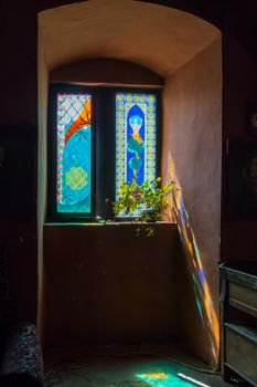 Window of the building with a remarkable stained glass, painted with interesting ornamental patterns