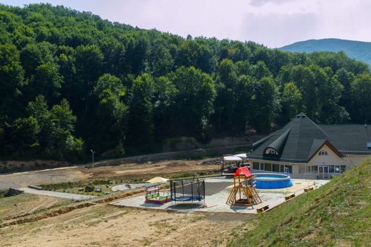 playground with pool in a country house with a forest in the background