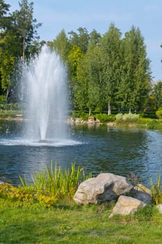 Excellent fountain in the middle of a small pond with stones on the shore