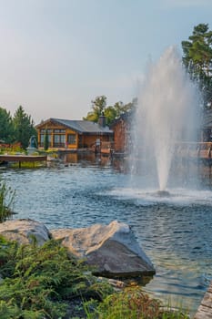 Beautiful decorative lake with a fountain on the background of the hotel complex