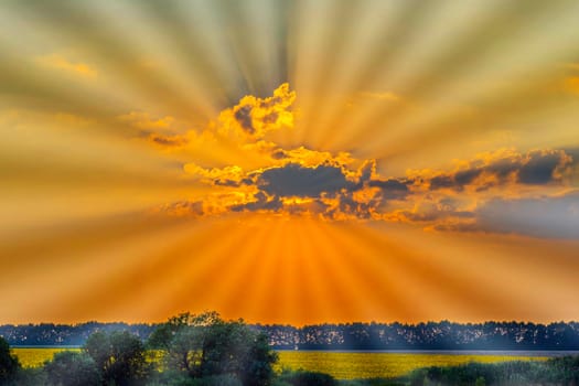 A beautiful landscape depicting a sun hiding behind a cloud over green fields