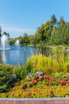 Park area with beautiful flower beds and a view of the lake with fonts