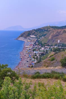 the coastline of the blue sea with a beach and a large number of hotels. Leave for tourists