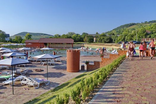 A large number of vacationers in the pool and on the sun loungers near it