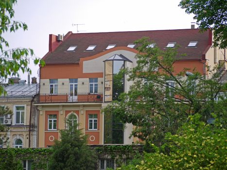 house with modern design on a city street in the background of trees
