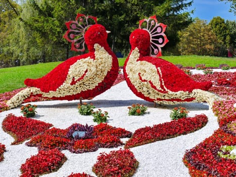 magnificent sculpture in the park in the form of two birds looking at each other made of bright colors