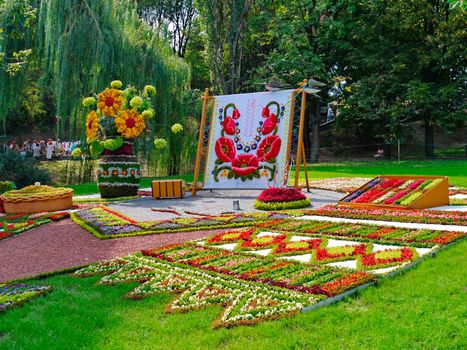 Beautiful flowerbed with sculptures made of a flower on it