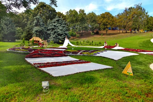 flowers on the green lawn in the park in the form of a national ornament