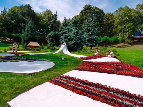 composition in a park on a green lawn on the theme of national customs