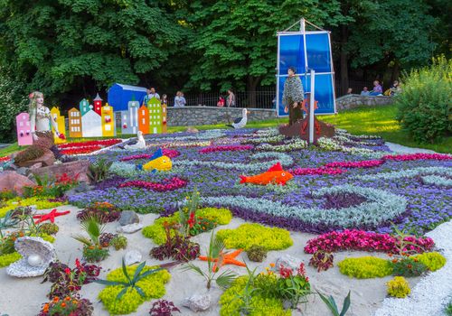 A large decorative flower bed of their flowers in the form of the sea with fish, mermaids, ships and other marine life.