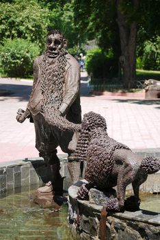 Fountain with sculptures of the characters of the tale of Buratino against the background of the park zone