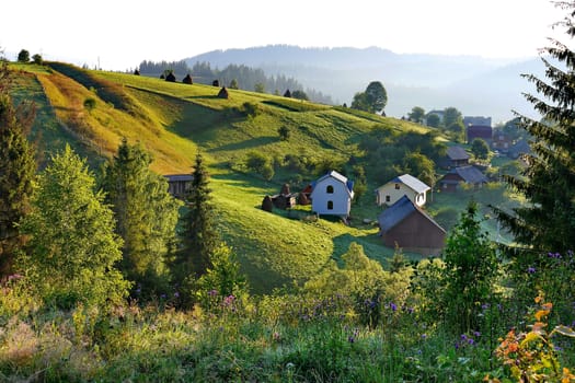 Little pretty houses with a backdrop of gently sloping green mountains