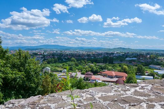 View from the wall of the old fortress to the village and the mountains on a cloudy day