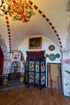 A room with a fireplace and ceiling paintings in the Mukachevo Palanok castle. Mukachevo Ukraine