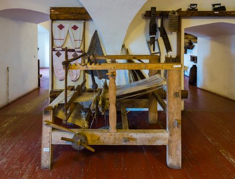 An old wooden spinning wheel. Now this is an exhibit in the museum