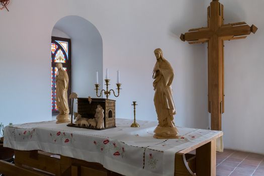 altar in the church of Mukachevo castle is decorated with a wooden cross and a bronze candlestick