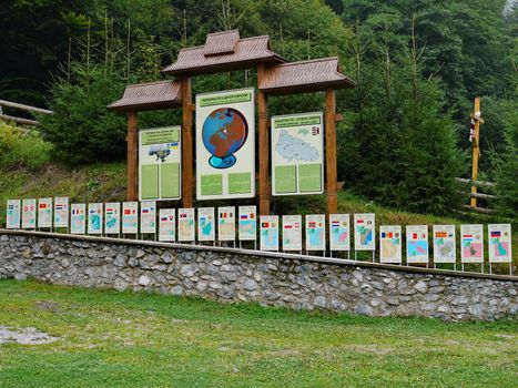 Information corner in the Carpathians with signs indicating important information for tourists