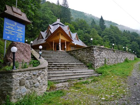 Stone steps leading to the entrance to the wooden building of the administration of the Carpathian Reserve