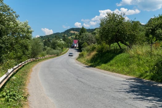 asphalt road between the mountainous two villages on a cloudy day