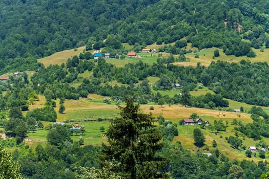 Luxurious landscape of a beautiful mountainous area with chaotic houses and picturesque nature with a glorious greenery.