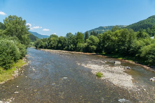 beautiful river with trees on the bank in the middle of the Carpathians