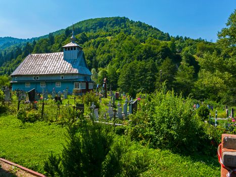 old cemetery near the village wooden church in the Carpathians on the mountain
