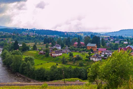 Green trees, blue mountains, a variety of roofs of houses and white clouds in the sky. What a beauty