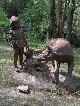 Sculpture in a park of a children's fairy tale wolf and a red cap. One of the favorite children's fairy tales.