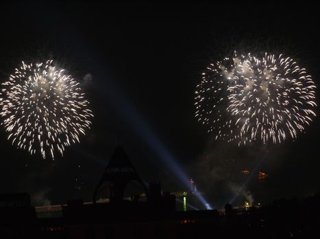 Scenic salute in the light of searchlights against the background of the night sky