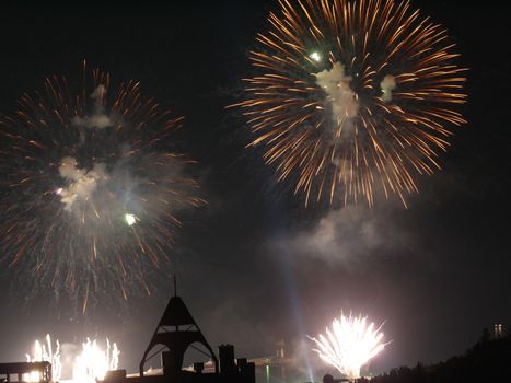 Bright flashes of fireworks on the black night sky. A great addition to any holiday