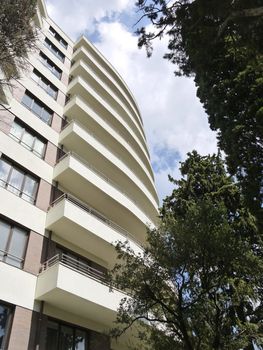 Wide balconies of the resort sanatorium against the background of the green park zone