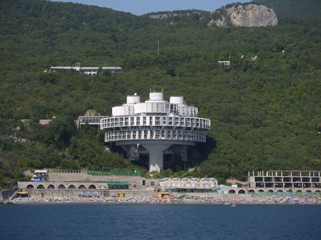 An interesting architectural building connected to the mountain corridor overlooking the sea beach