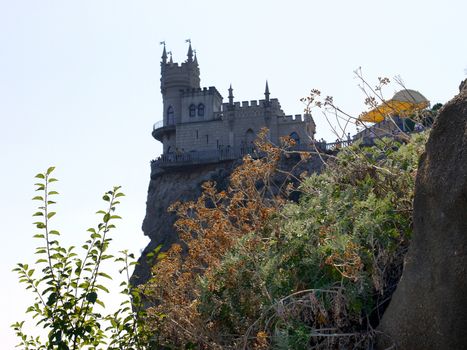A picturesque view from afar to the famous Crimean Swallow's nest in the rays of the summer sun